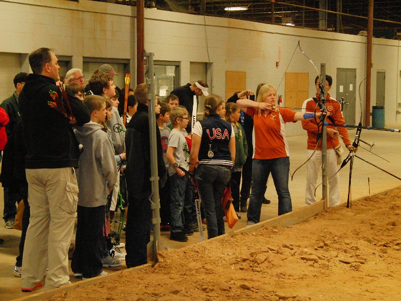 CIMG5676.JPG - Lindsey Carmichael speaks to the crowds while UT archer Renae Patowski and Sheng-Cheng (Hans) Huang demo an olympic style of shooting.